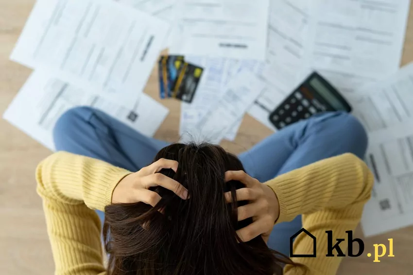 Załamana kobieta nad dokumentami