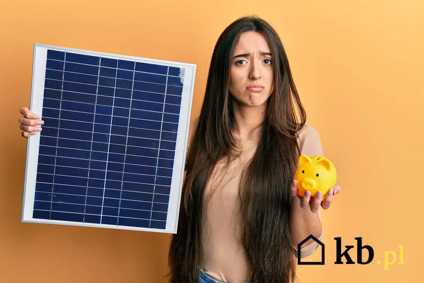 kobieta trzyma moduł PV i skarbonkę