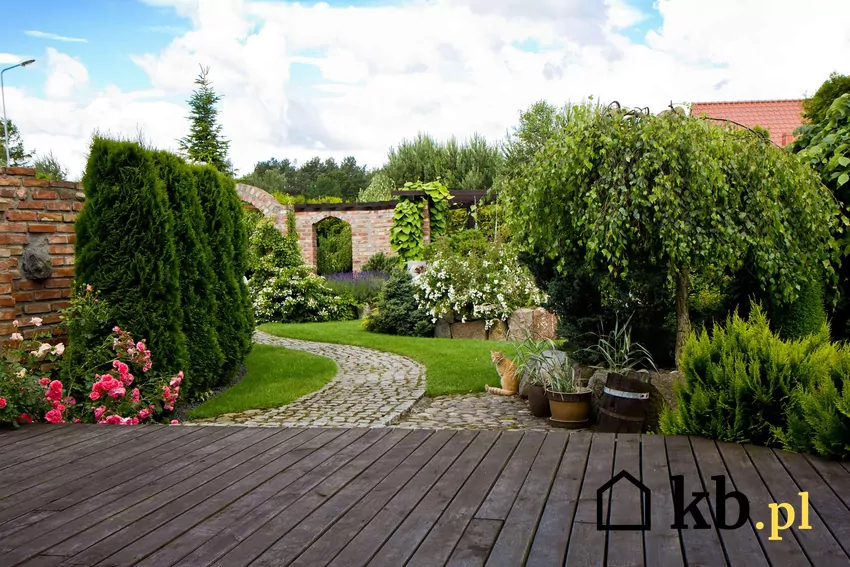 Wykonanie dodatkowych elementów przed budynkiem wpływa na koszty budowy domu Widok na taras i ogród