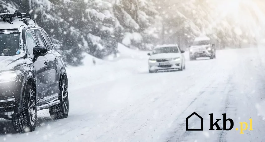 samochody jadą po zaśnieżonej drodze