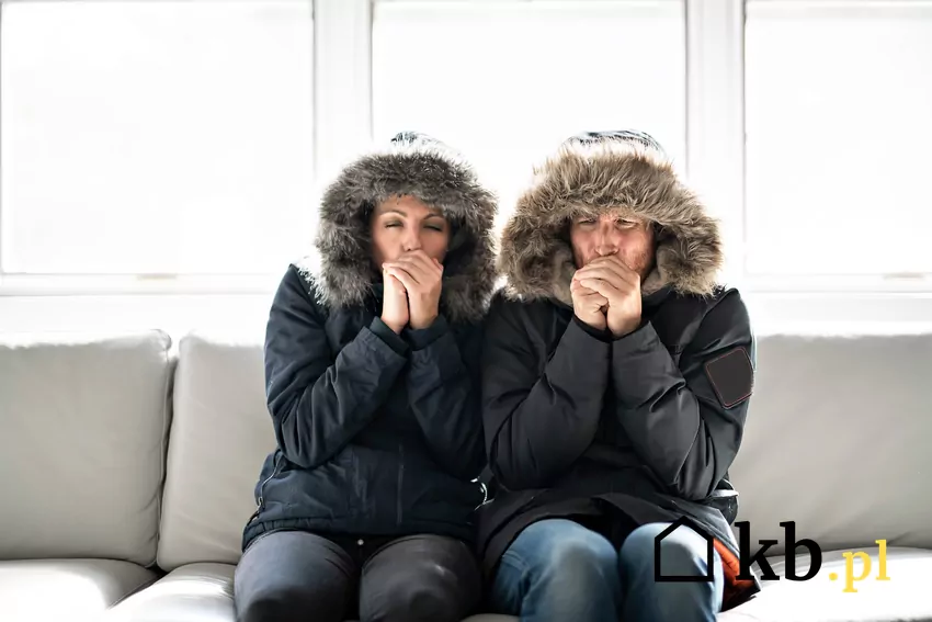 kobieta i mężczyzna ubrani w kurtki siedzą na kanapie