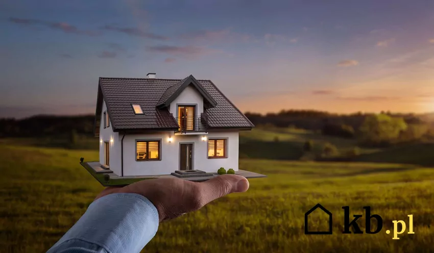 Grafika domu trzymanego na otwartej dłoni