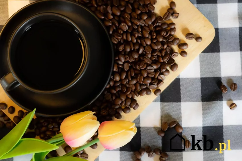 Kawa zaparzona w filiżance, obok ziarna kawy