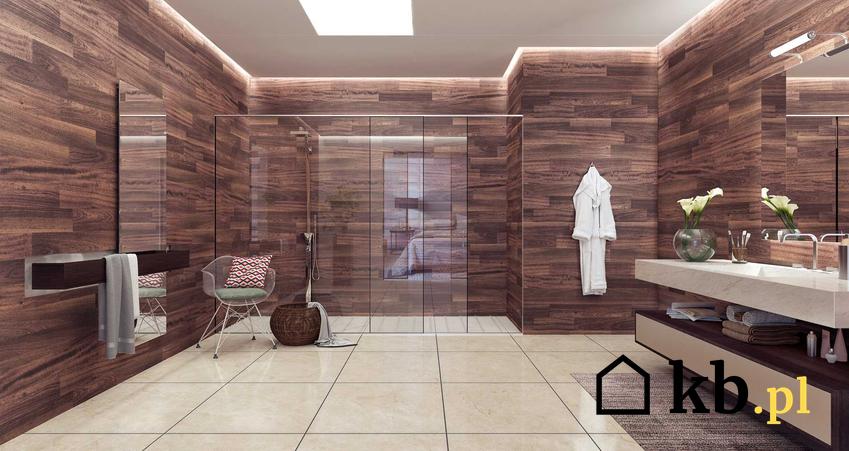 Przesuwne drzwi do kabiny pryszninowej w pięknie zaaranżowanej łazience w kolorze brązu i beżu, a także rodzaje i producenci drzwi przesuwnych